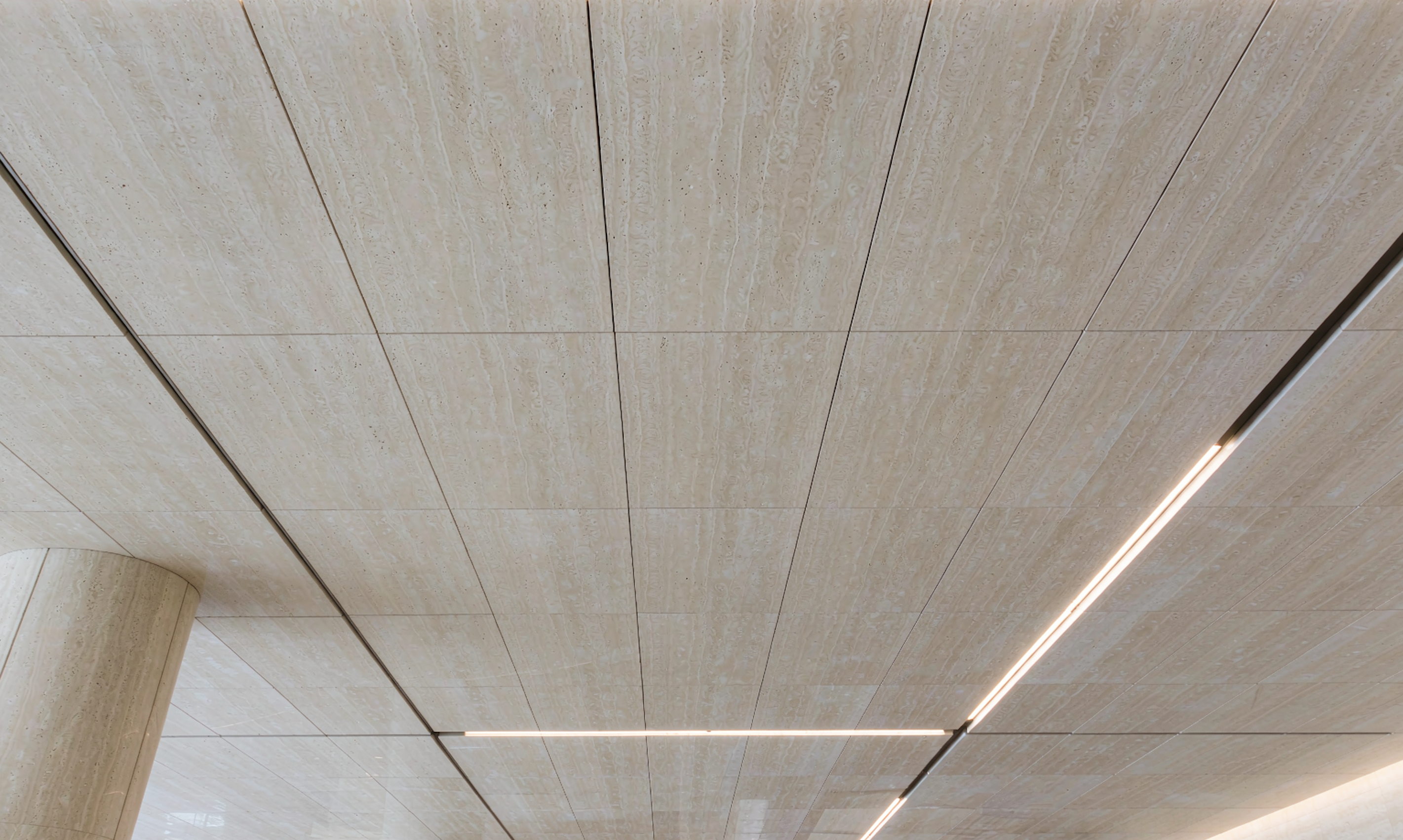 Stone-look ceiling panels with recessed linear lighting